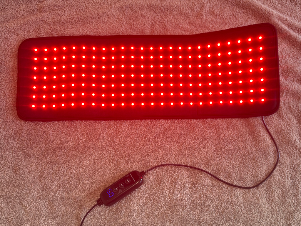 Red light therapy device used during restorative energy massage